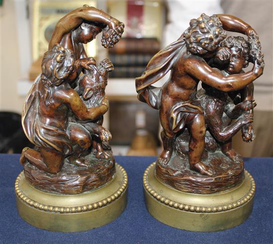 A pair of late 19th / early 20th century patinated bronze putti groups, 9.25in.